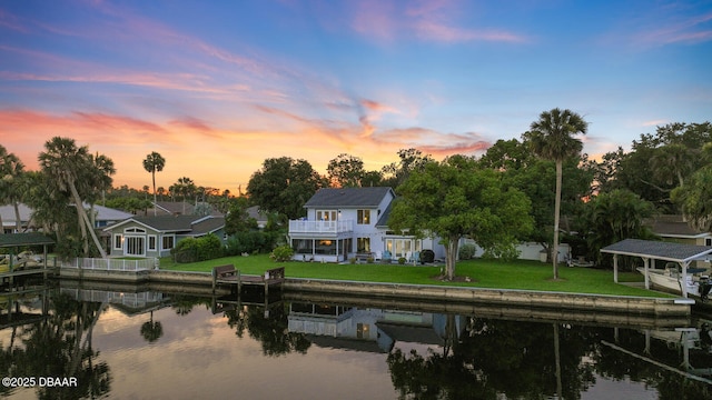 453 Palm Ave, Ormond Beach, FL 32174 - rear view of house featuring a water view and a lawn