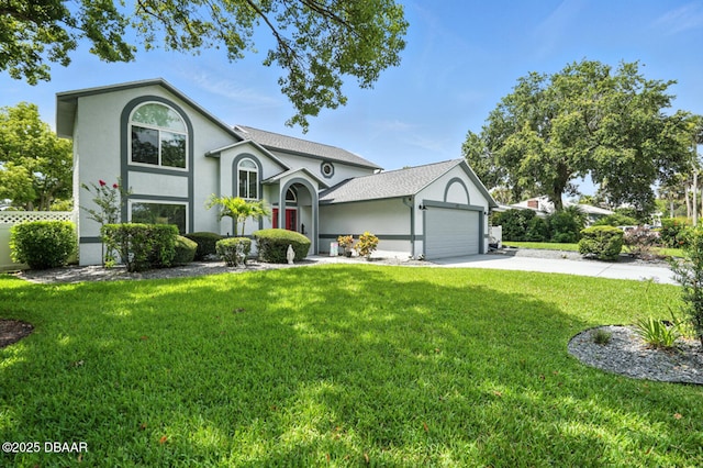 453 Palm Ave, Ormond Beach, FL 32174 - view of front of home with an attached garage, stucco siding, a front lawn, and driveway