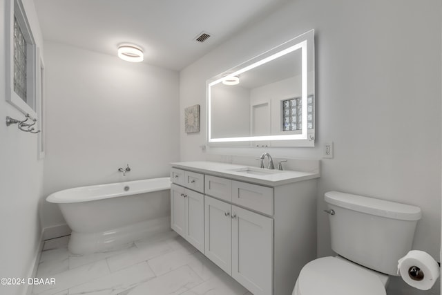 bathroom with a washtub, toilet, and vanity