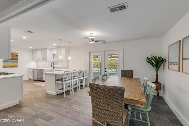 dining area featuring ceiling fan, french doors, and sink