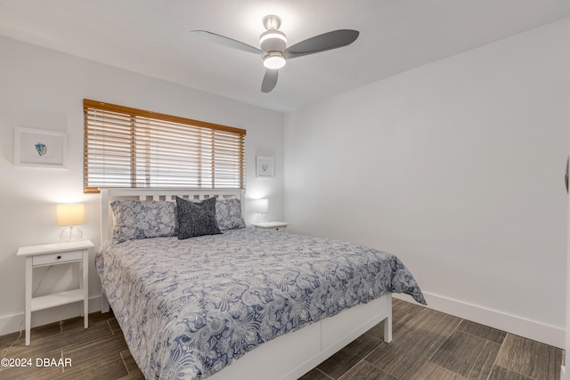 bedroom featuring ceiling fan and dark hardwood / wood-style floors