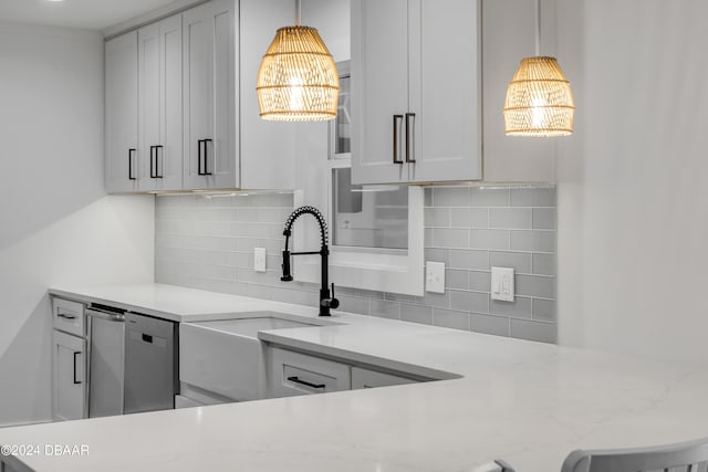 kitchen with backsplash, white cabinetry, light stone counters, and an inviting chandelier