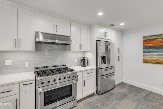 kitchen with decorative backsplash, white cabinetry, and stainless steel appliances