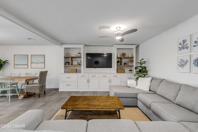 living room with ceiling fan and light hardwood / wood-style flooring