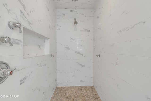 bathroom with a tile shower