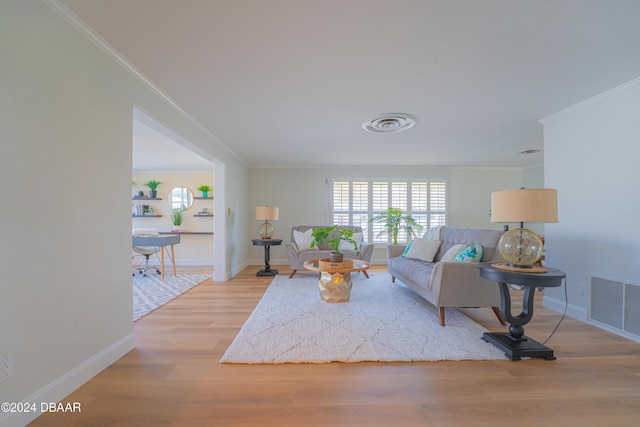 living room featuring light hardwood / wood-style floors and ornamental molding