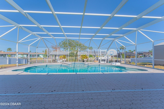 view of pool with a patio area, a lanai, and an in ground hot tub