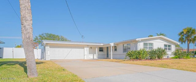 ranch-style home with a garage and a front yard