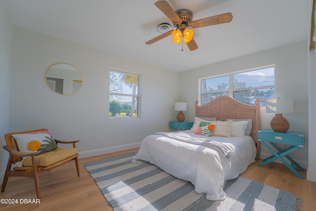 bedroom with light wood-type flooring and ceiling fan