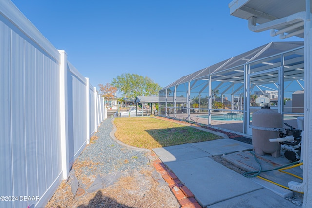 view of yard featuring a lanai and a patio