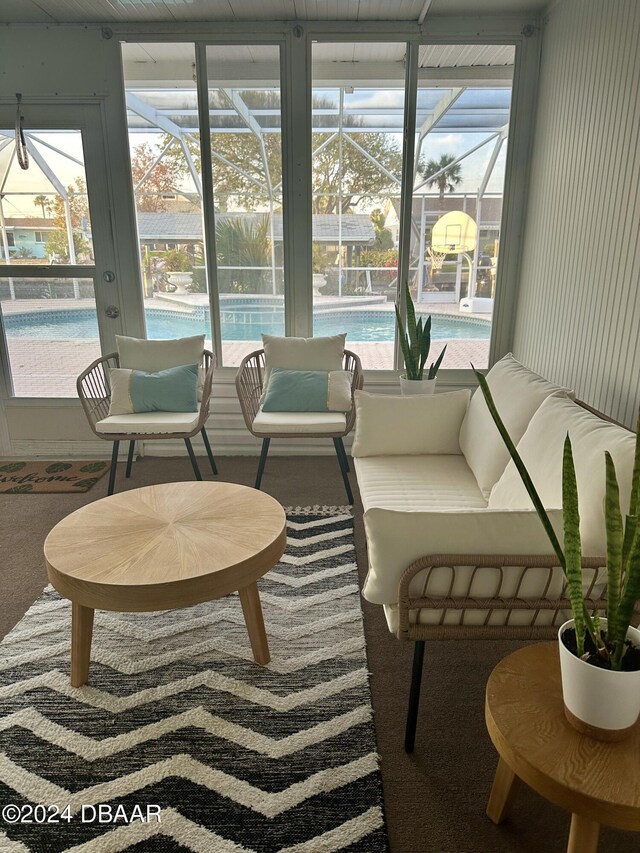 sitting room featuring wood-type flooring, a wealth of natural light, and crown molding