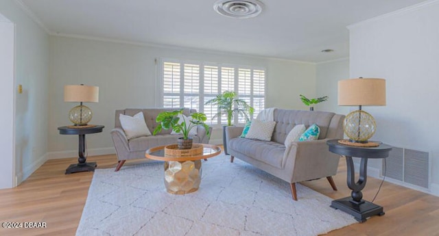 living room featuring hardwood / wood-style floors and crown molding