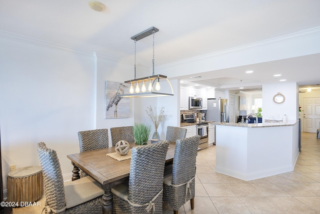 dining space with light tile patterned floors and ornamental molding