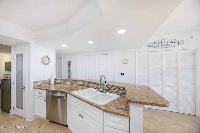 kitchen with sink, white cabinets, stainless steel dishwasher, kitchen peninsula, and light tile patterned flooring