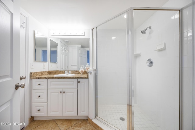 bathroom featuring tile patterned floors, vanity, and an enclosed shower