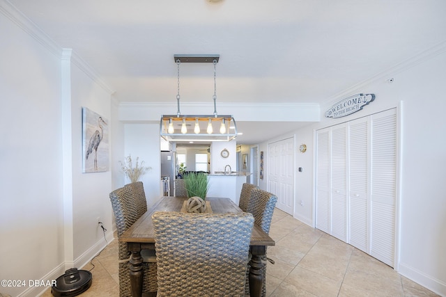 dining room featuring ornamental molding, sink, and light tile patterned floors