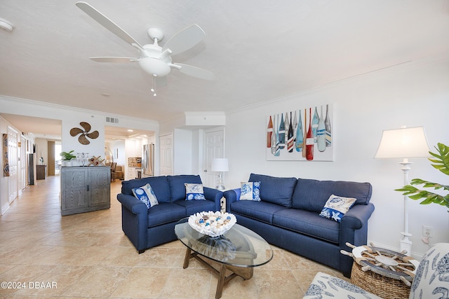 living room with crown molding and ceiling fan