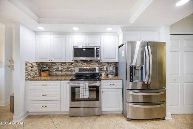 kitchen featuring backsplash, dark stone countertops, white cabinetry, and stainless steel appliances