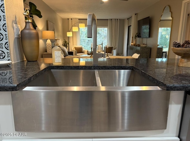 kitchen featuring sink and dark stone counters