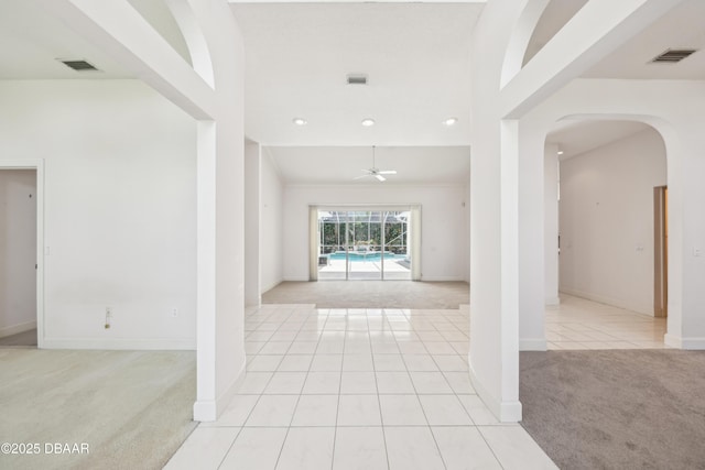 entrance foyer featuring visible vents, baseboards, and light carpet
