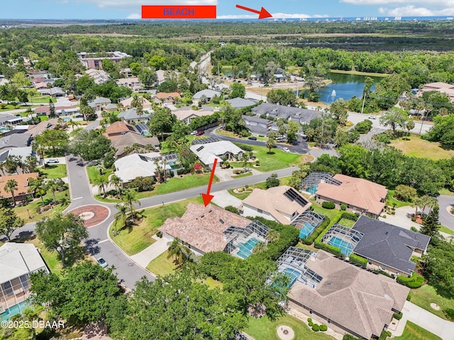 drone / aerial view with a water view and a residential view