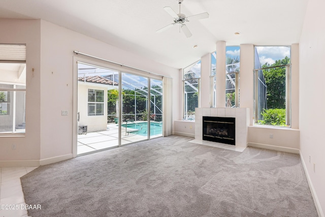 unfurnished living room with baseboards, a ceiling fan, carpet flooring, and a sunroom