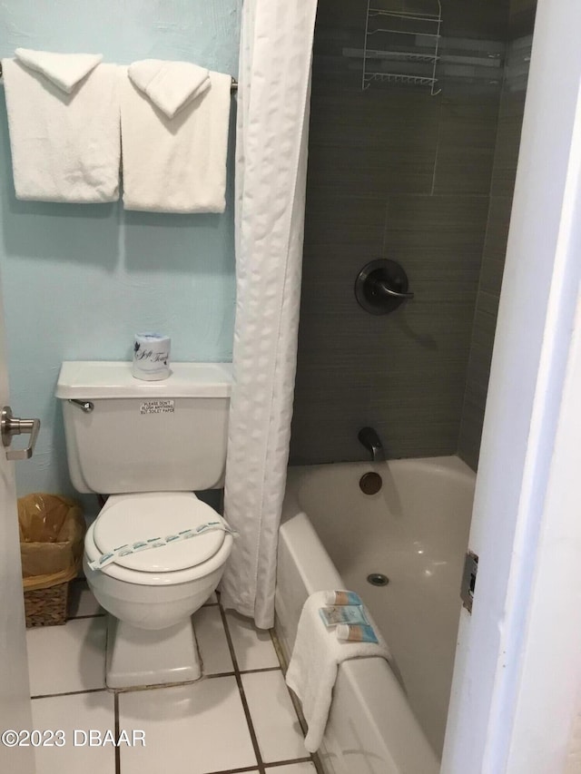 bathroom with tile patterned floors, toilet, and shower / tub combo