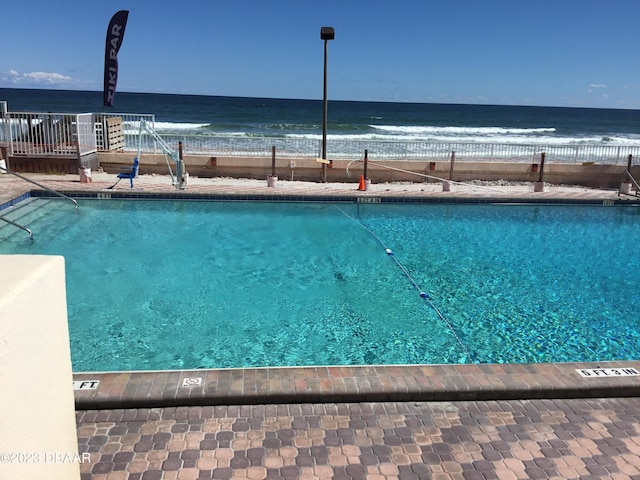 view of swimming pool featuring a water view