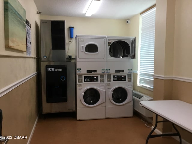 laundry area with stacked washer and dryer and washer and clothes dryer