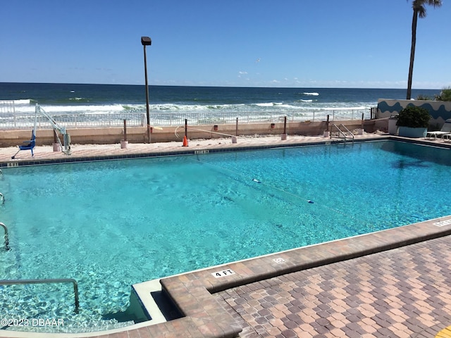 view of pool with a water view