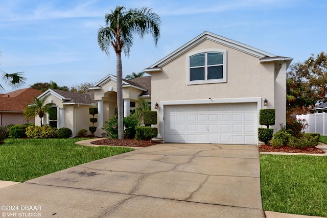 view of front of property featuring a front lawn and a garage