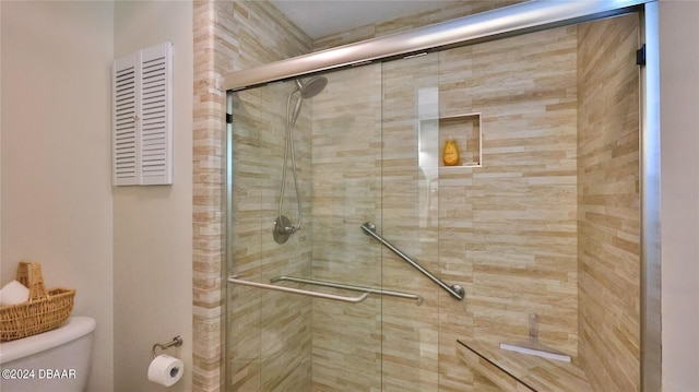 bathroom with an enclosed shower and toilet