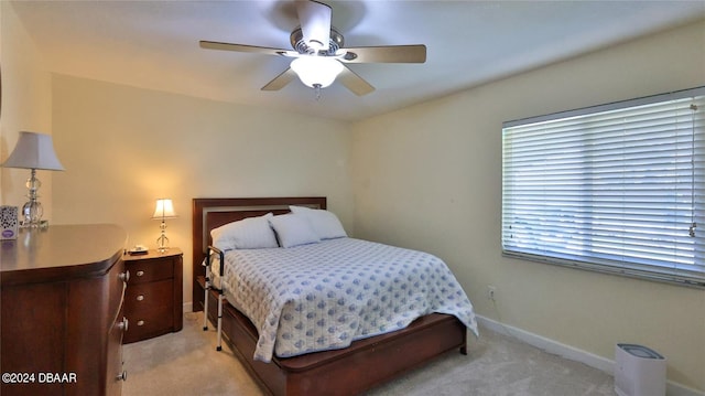 bedroom with light carpet and ceiling fan