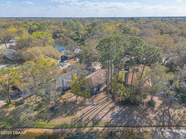birds eye view of property with a view of trees