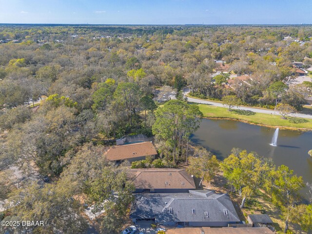 aerial view with a wooded view and a water view