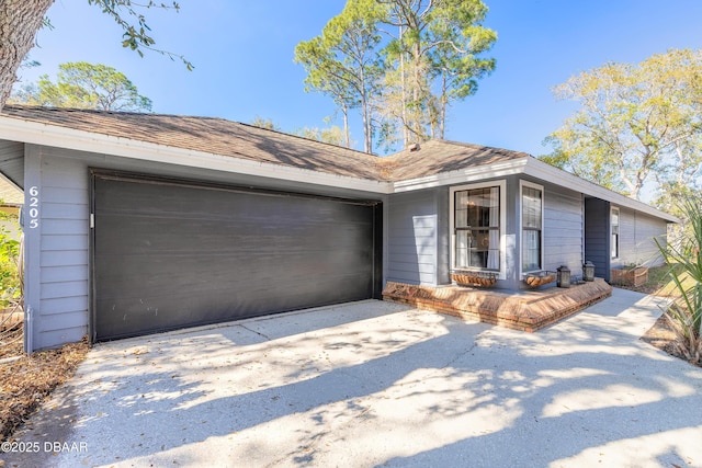 view of front of property with a garage and concrete driveway