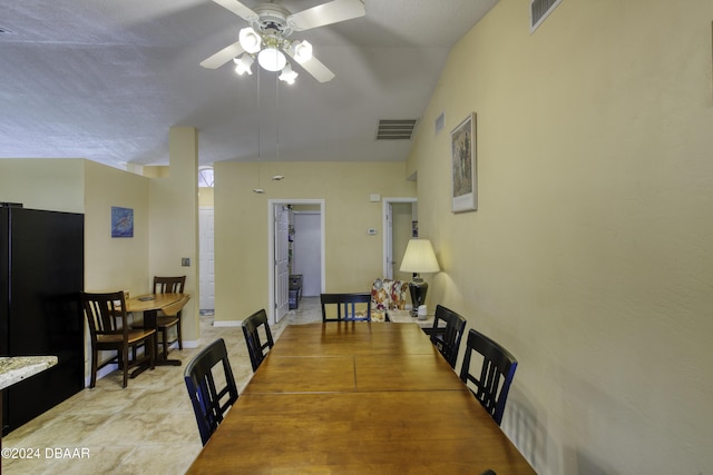 dining room with ceiling fan and vaulted ceiling