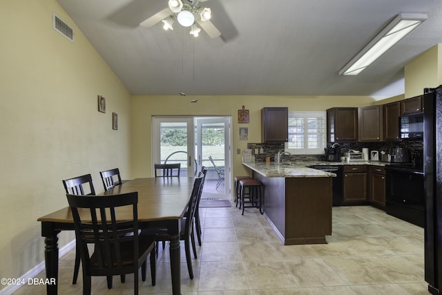 kitchen with black appliances, decorative backsplash, ceiling fan, and vaulted ceiling