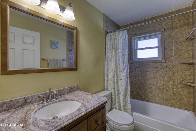 full bathroom featuring vanity, toilet, shower / bath combo with shower curtain, and a textured ceiling