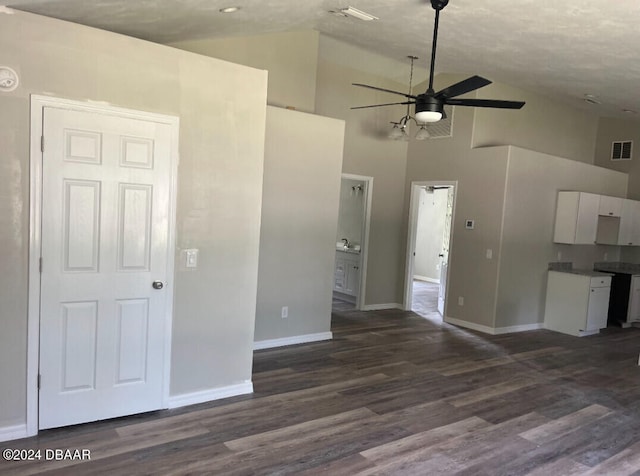 unfurnished living room with ceiling fan, dark wood-type flooring, and high vaulted ceiling