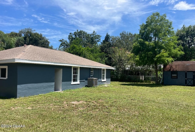 exterior space with central air condition unit and a storage shed