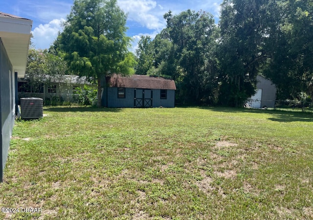 view of yard featuring a shed and cooling unit