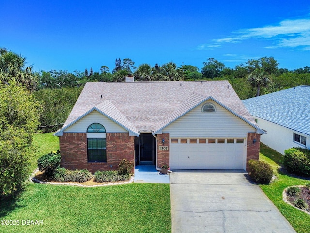 1307 Wayne Ave, New Smyrna Beach, FL 32168 - ranch-style home with driveway, an attached garage, a front yard, brick siding, and roof with shingles