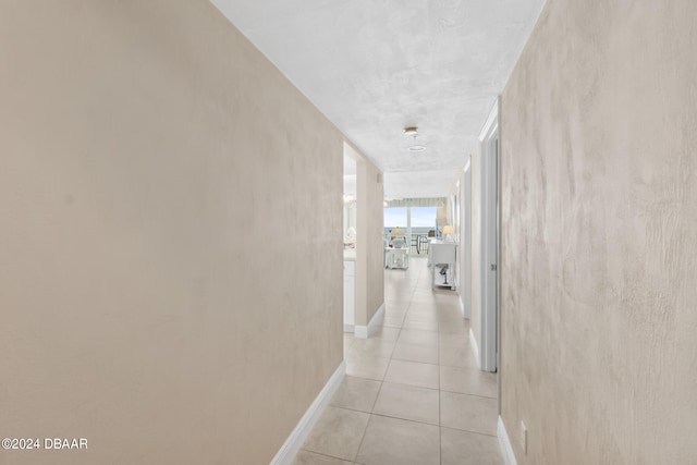 hall with light tile patterned floors