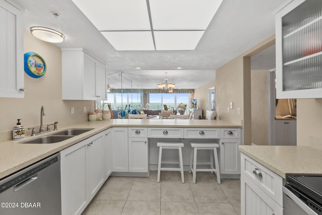 kitchen featuring sink, light tile patterned floors, an inviting chandelier, stainless steel dishwasher, and white cabinets