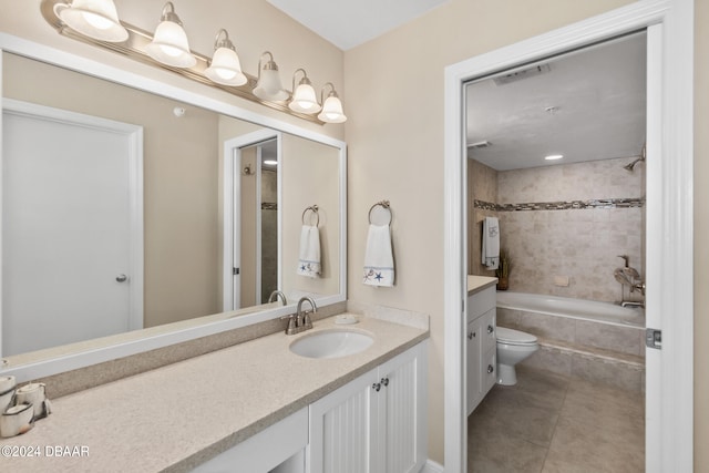 full bathroom featuring toilet, tiled shower / bath, tile patterned floors, and vanity