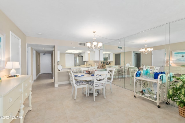 tiled dining area with a chandelier and sink