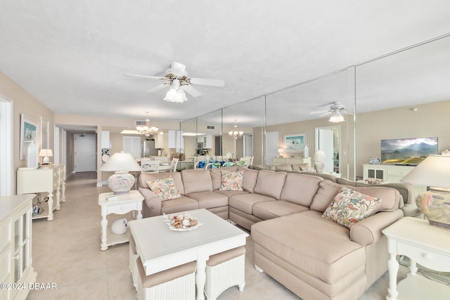 living room with ceiling fan with notable chandelier