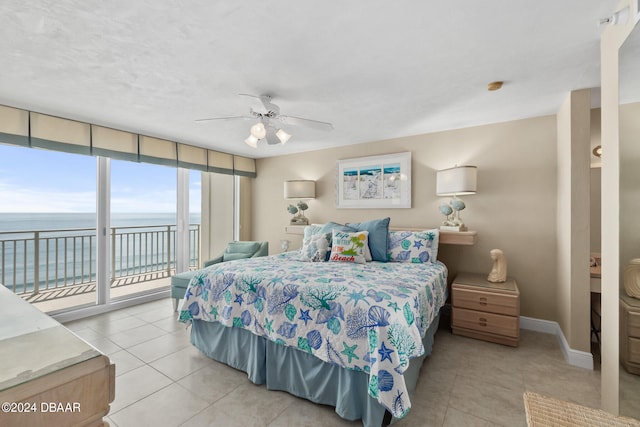 tiled bedroom featuring ceiling fan, a water view, and access to outside