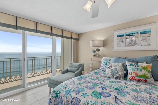 tiled bedroom with ceiling fan, access to exterior, and a water view